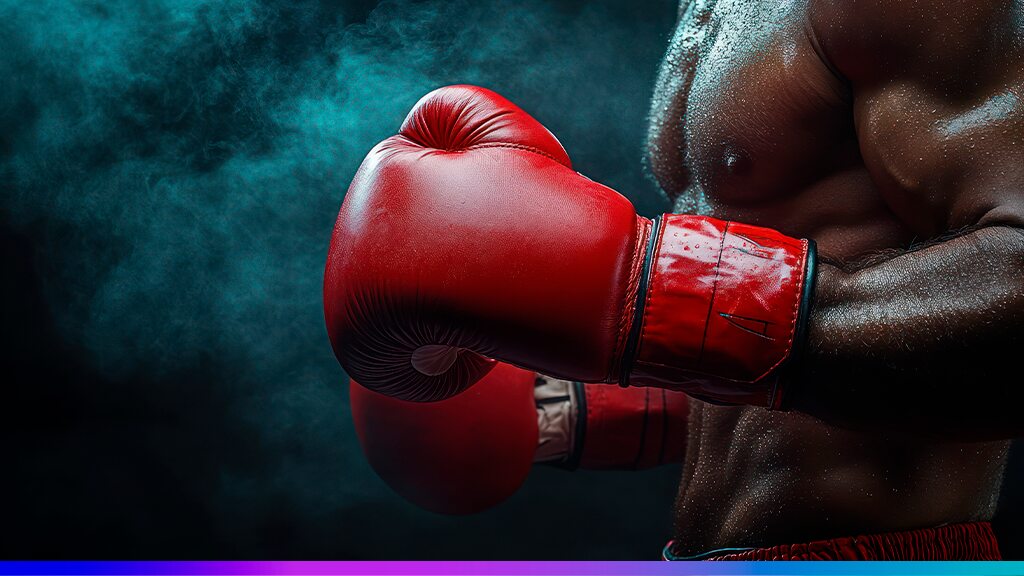 Lutador com luvas de boxe vermelhas em posição de combate, representando análise de perfil, estratégia e preparação para desafios